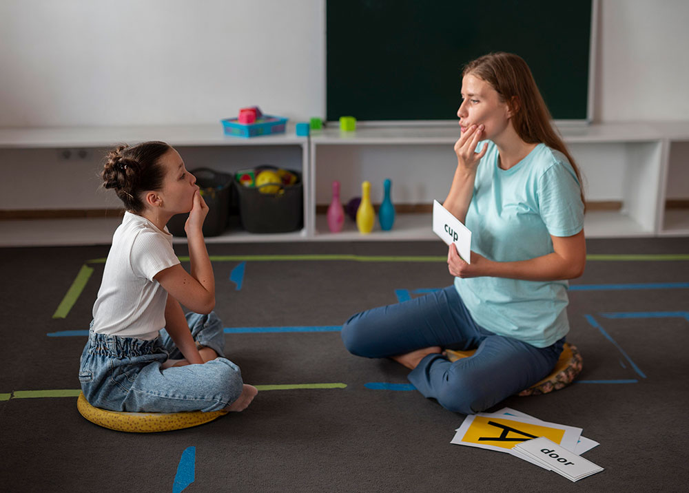 psychologist-helping-girl-speech-therapy-low psychologist-helping-girl-speech-therapy-low